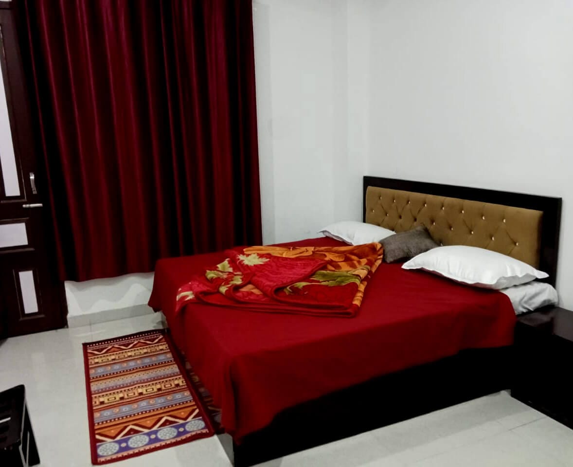 Deluxe Guest Room Red Interior at Shree Ram Hotel